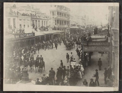 photo of geaorge street with lots of people and some horses